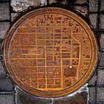 image for Oklahoma Manhole Covers have a city map on it with a white dot showing where in the city you are.
