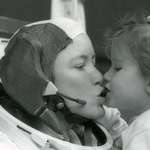 image for Astronaut Anna Fisher kisses her daughter Kristin after training in Houston for a spacewalk in 1985. Photo/NASA She became the first mother in space on November 8, 1984.