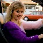 image for In Fast Times at Ridgemont High (1982), the pretty girl in the corvette is played by Nancy Wilson, member of the rock band Heart. She was dating screenwriter Cameron Crowe, and later married him.