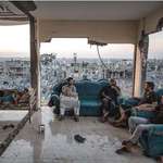image for Palestinian family sitting in their living room after Israeli air strike