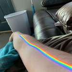 image for A vibrant and clear spectrum of colors refracting through my apparently prismatic window onto my arm.
