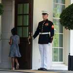 image for A Marine holds the door as Gianna Floyd, the daughter of George Floyd, walks into the White House.