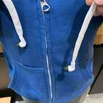 image for My co-worker’s hoodie has headphones threaded through the drawstring.