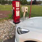 image for This Tesla charger set up to look like a vintage gas pump.