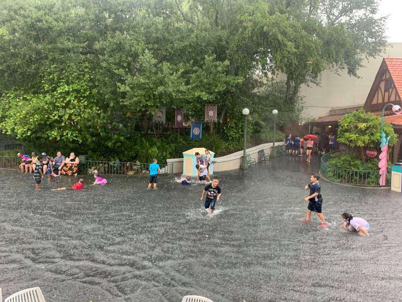 image for Water park? Disney guests swim in flooded Magic Kingdom streets