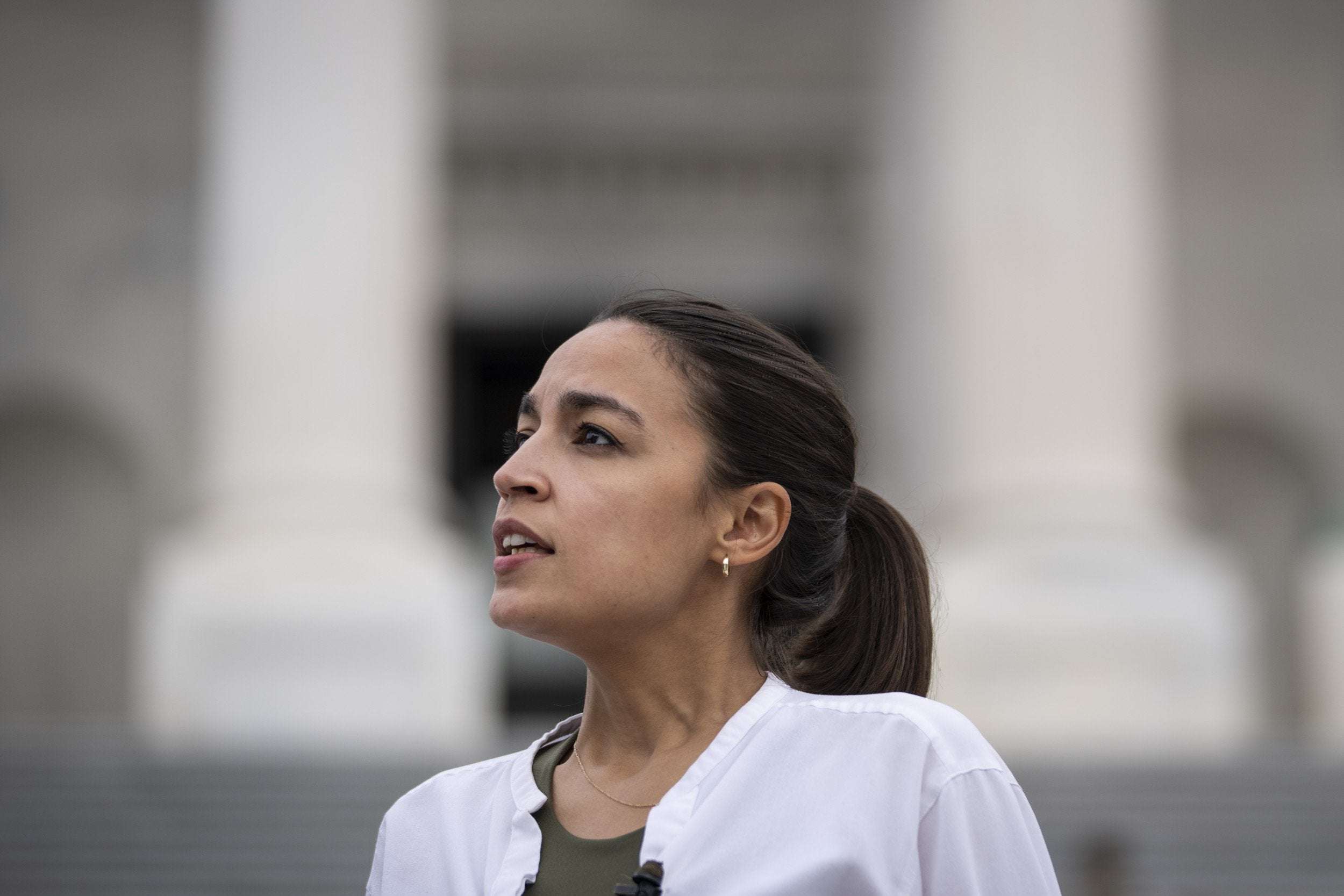 image for AOC Says It's 'Absolutely Wild' Members of Congress Can Buy and Sell Stocks