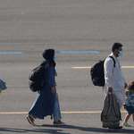 image for A girl skips across the tarmac as she and her family evacuated from Afghanistan arrive in Belgium