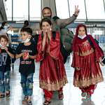 image for A family evacuated from Afghanistan arrives at Dulles International Airport in Chantilly, Virginia