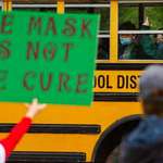 image for Masked schoolkid protests school mask protesters.