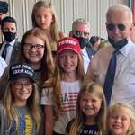 image for Biden taking a photo with some happy kids