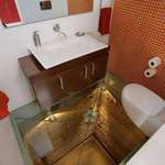 image for Bathroom with a glass floor over an abandoned elevator shaft