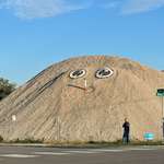 image for Someone periodically adds a face to this big gravel pile