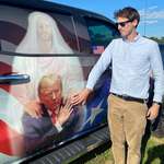 image for Jason Selvig in front of truck with painting that looks like Trump getting bent over by Jesus