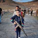 image for Little Armenian girl training with a machine gun to protect her village bordering Azerbaijan/Turkey