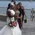 image for Two brides pause to take a picture together (Detroit waterfront)
