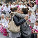 image for Two women kissing in front of an anti-gay protest.