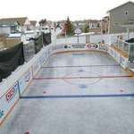 image for Two houses in Red Deer Alberta Join backyards every winter to make a hockey rink for kids.