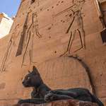 image for A picture of a cat in front of an Egyptian temple.