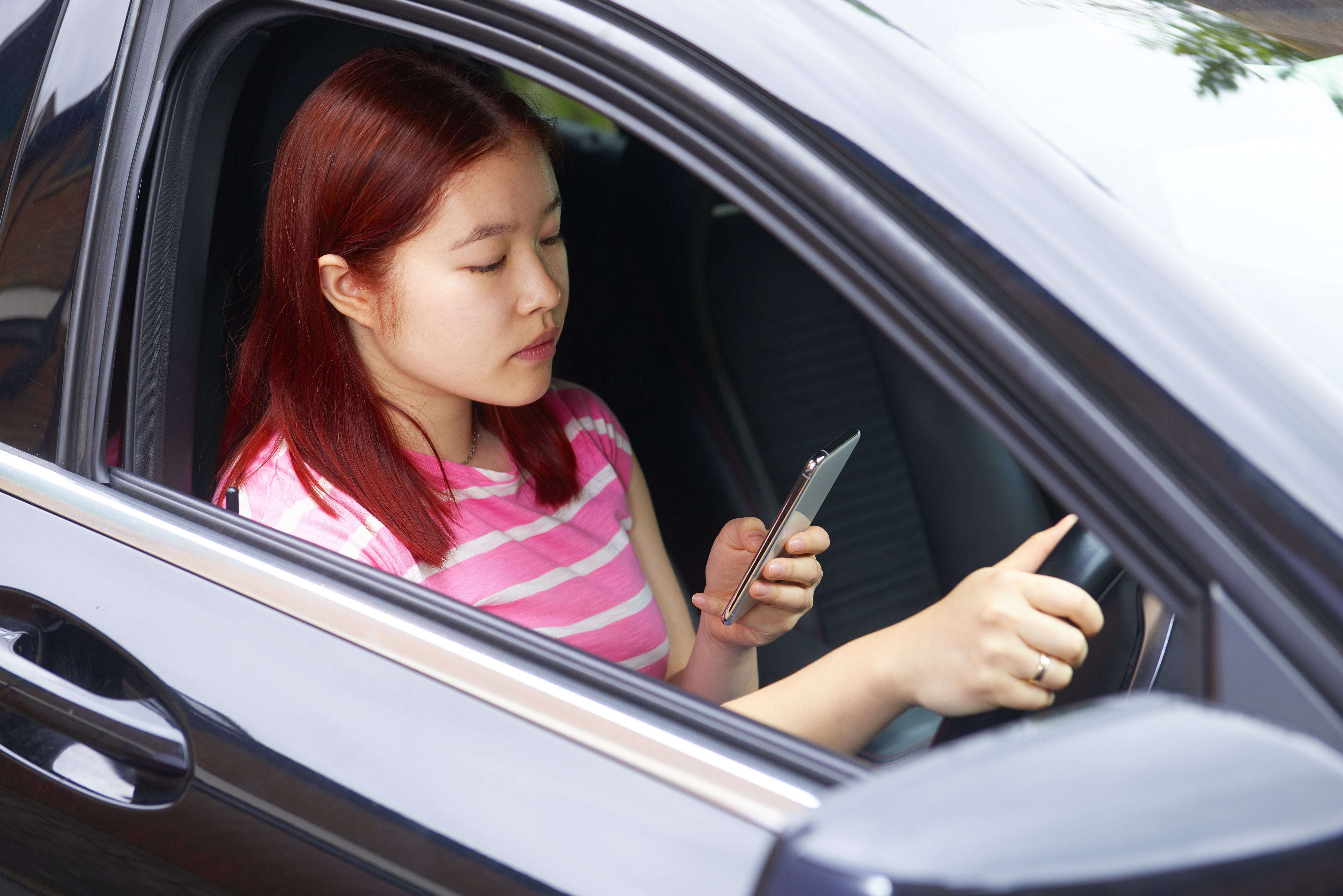 image for UK to ban any handheld use of a mobile phone behind the wheel