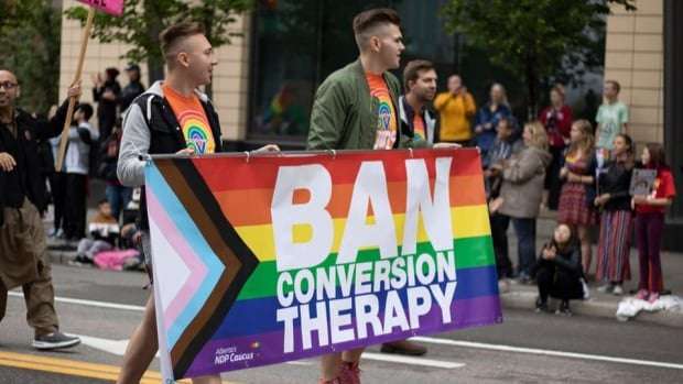image for MPs embrace after bill to ban conversion therapy passes unanimously in House