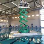 image for Workers on a scissor lift floating in a swimming pool