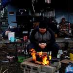 image for Tornado survivor sits by a fire outside his home to boil eggs and stay warm in Mayfield, Kentucky