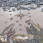 image for Amazing Christmas art using stones on a beach.