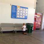 image for Boy praying in front of missing children poster at Walmart