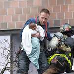 image for A Bronx fighter fighter saving a baby from a massive 2 Alarm fire