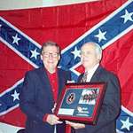 image for A picture of Mitch McConnell with a Confederate battle flag in the background