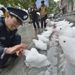 image for Chinese security guard has fun at work after a heavy snowfall.