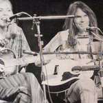 image for Joni Mitchell on stage with Neil Young. She has removed her music from Spotify.