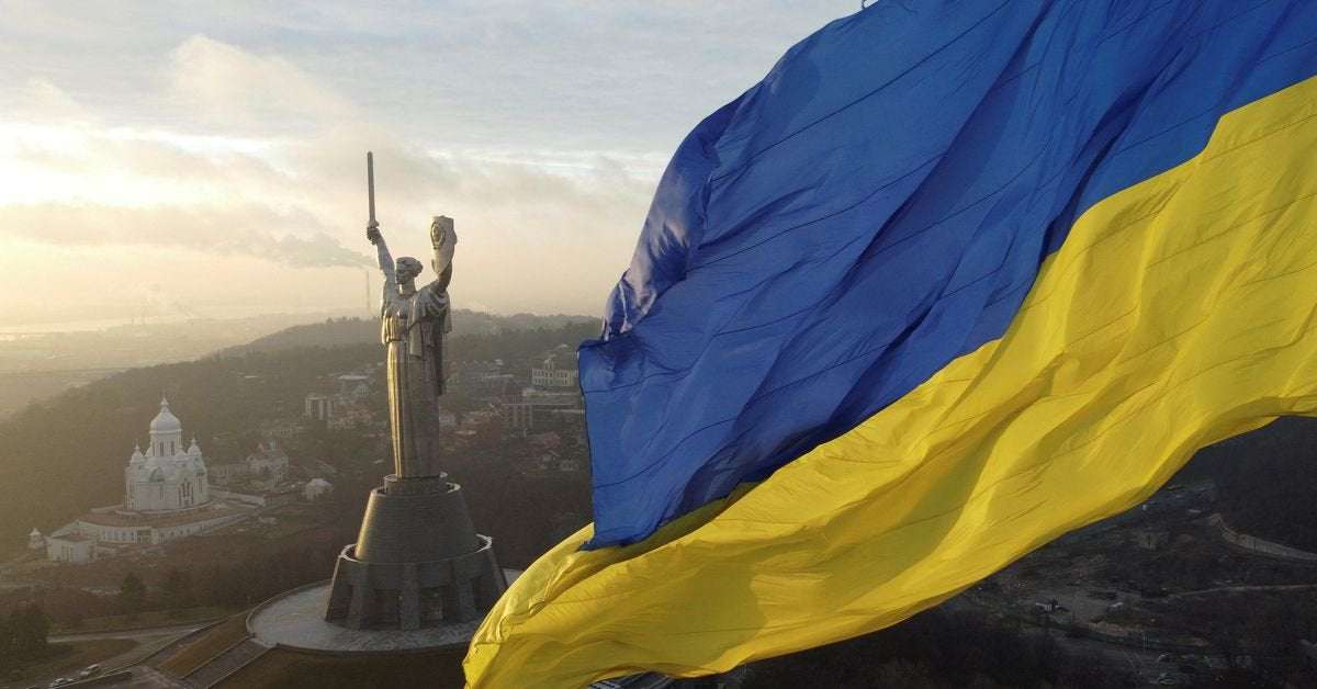 image for "We fear no one:" Ukrainians raise flags to defy Russia invasion fear