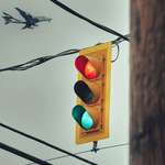 image for ITAP of a broken stoplight with a giant bird in the back