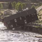 image for The moment a house collapsed into the Yellowstone river during unprecedented flooding. June 13, 2022