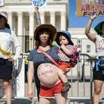 image for Pregnant woman protesting against supreme court decision about Roe v. Wade.