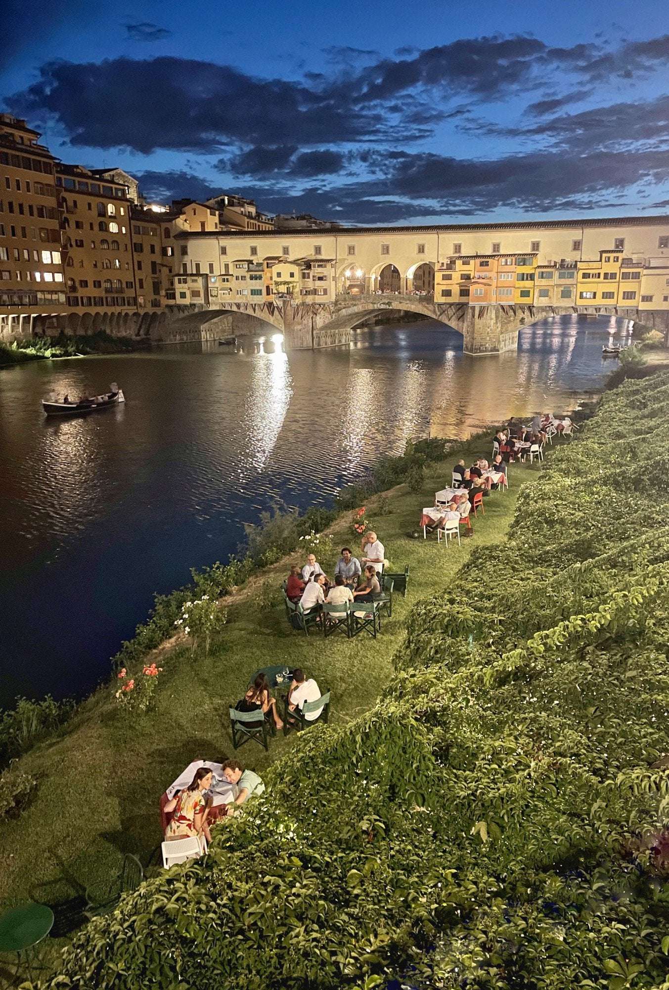 image showing ITAP of people having dinner near Arno river in Florence