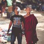 image for young buddhist monk next to a metalhead friend