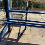 image for An uncomfortable three beam bench at a hospital bus stop