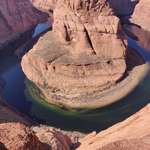image for All the pics of horseshoe bend never do it justice. Here it is with a boat for scale.