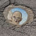 image for Someone in my city is filling potholes with mosaics