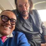 image for Keanu Reeves flying on economy class next to a fan grasping this opportunity by getting a selfie.