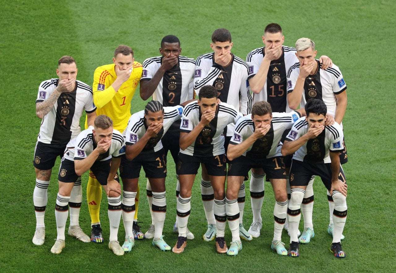 image showing German football team covers their mouths at their first game in Qatar