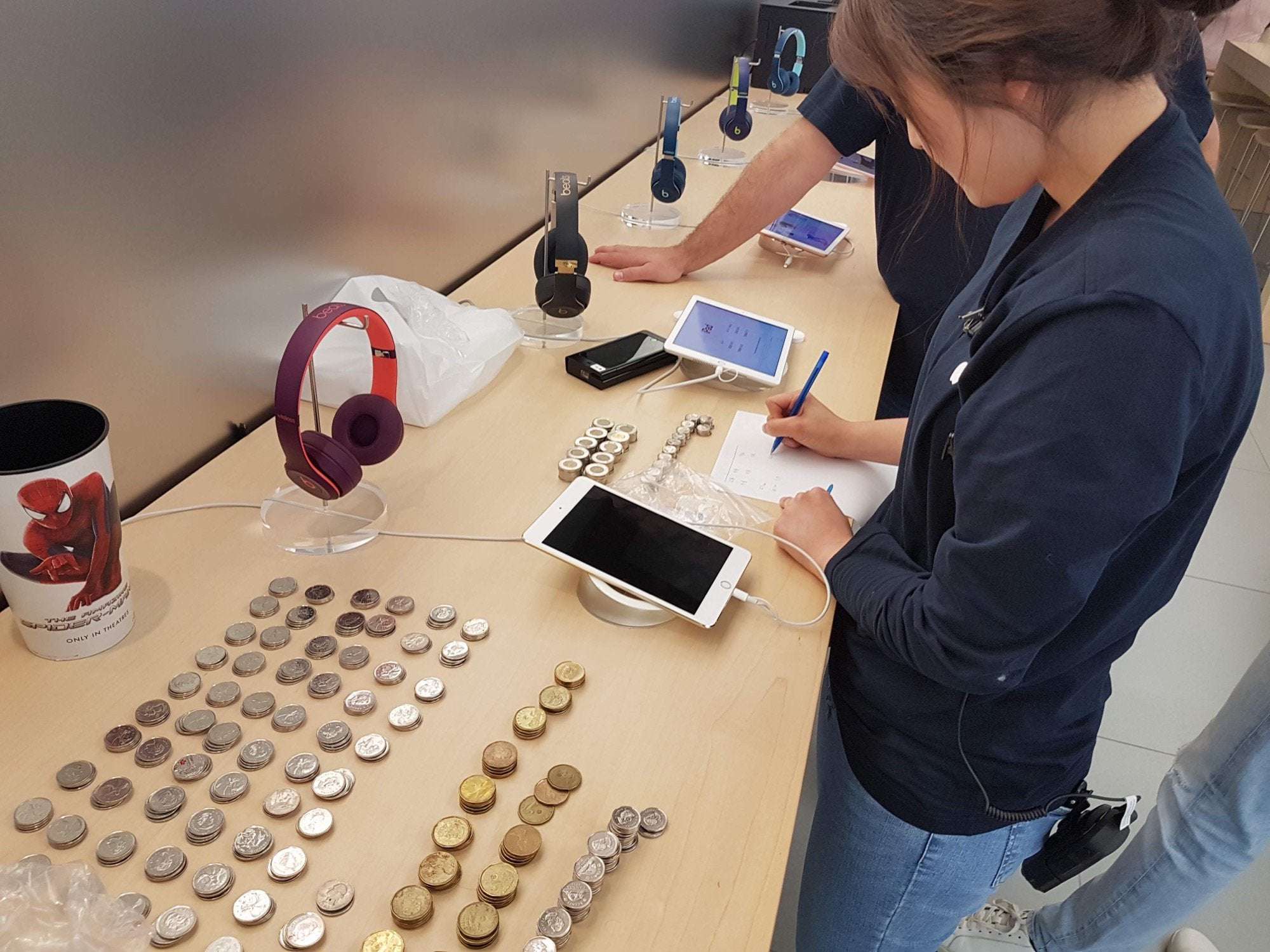 image showing Buying an iPad in the Apple store with hundreds of dollars in coins
