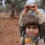 image for Syrian girl mistakes camera for gun in heartbreaking photo, 2015