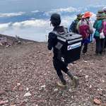 image for Delivery man trekking on Mount Fuji