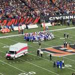 image for Entire Bills team in prayer as Damar Hamlin leaves the field in an ambulance.