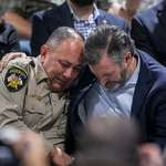 image for Ted Cruz consoling a police officer who didn't intervene in the Uvalde shooting