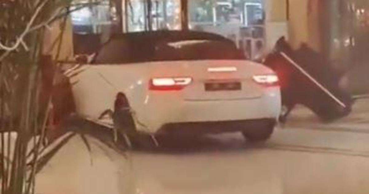 image for Wild video shows angry guest smashing sports car through Chinese hotel lobby: "Are you crazy?"