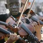 image for Brazilian boy (12) playing violin at the funeral of his teacher who rescued him from poverty & crime